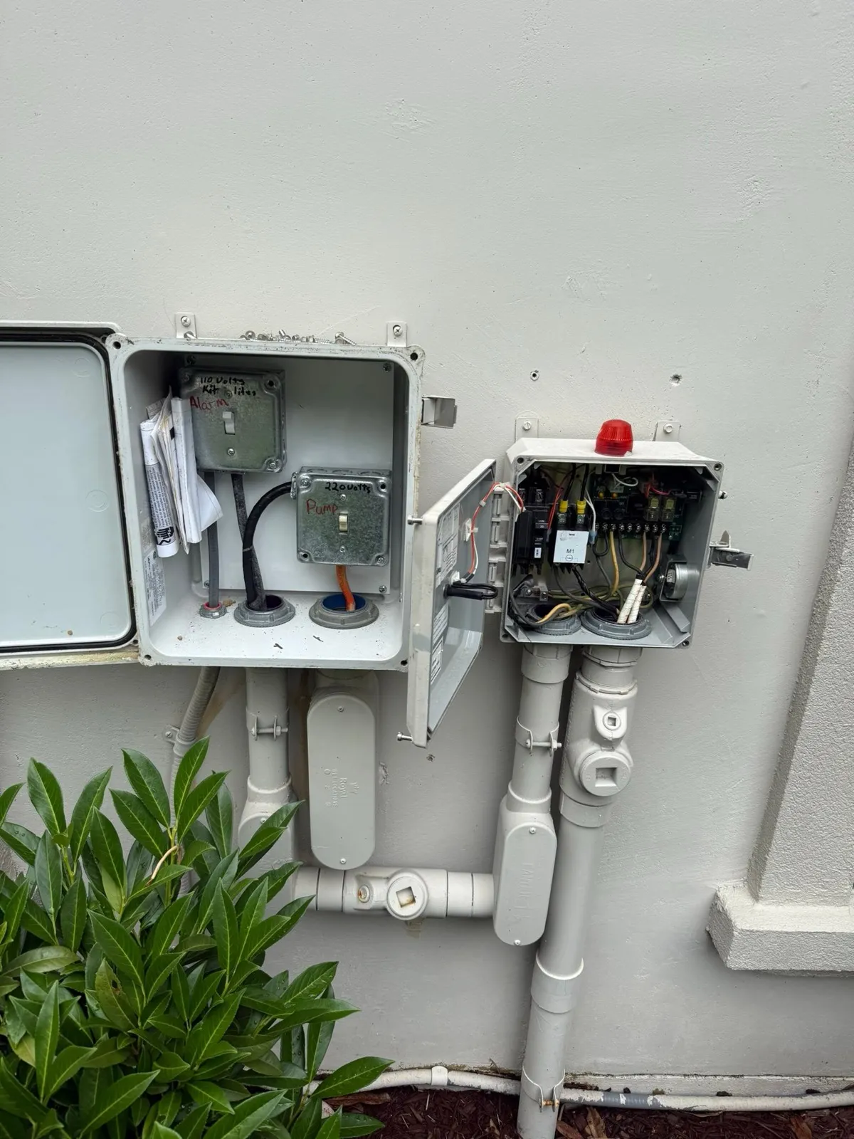 Septic system control panel mounted beside a house