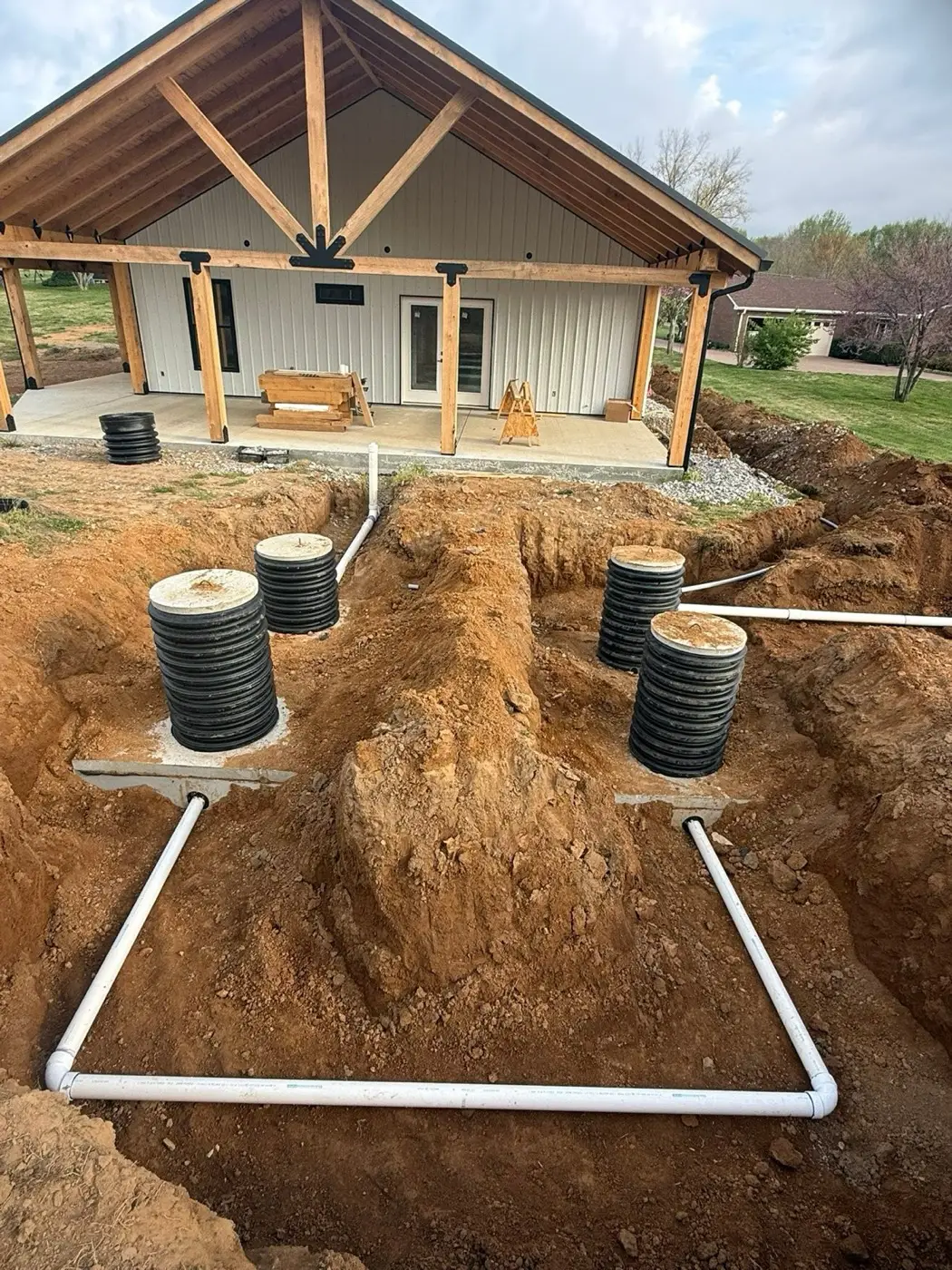 Two septic tank risers set and plumbed on a new system before backfill