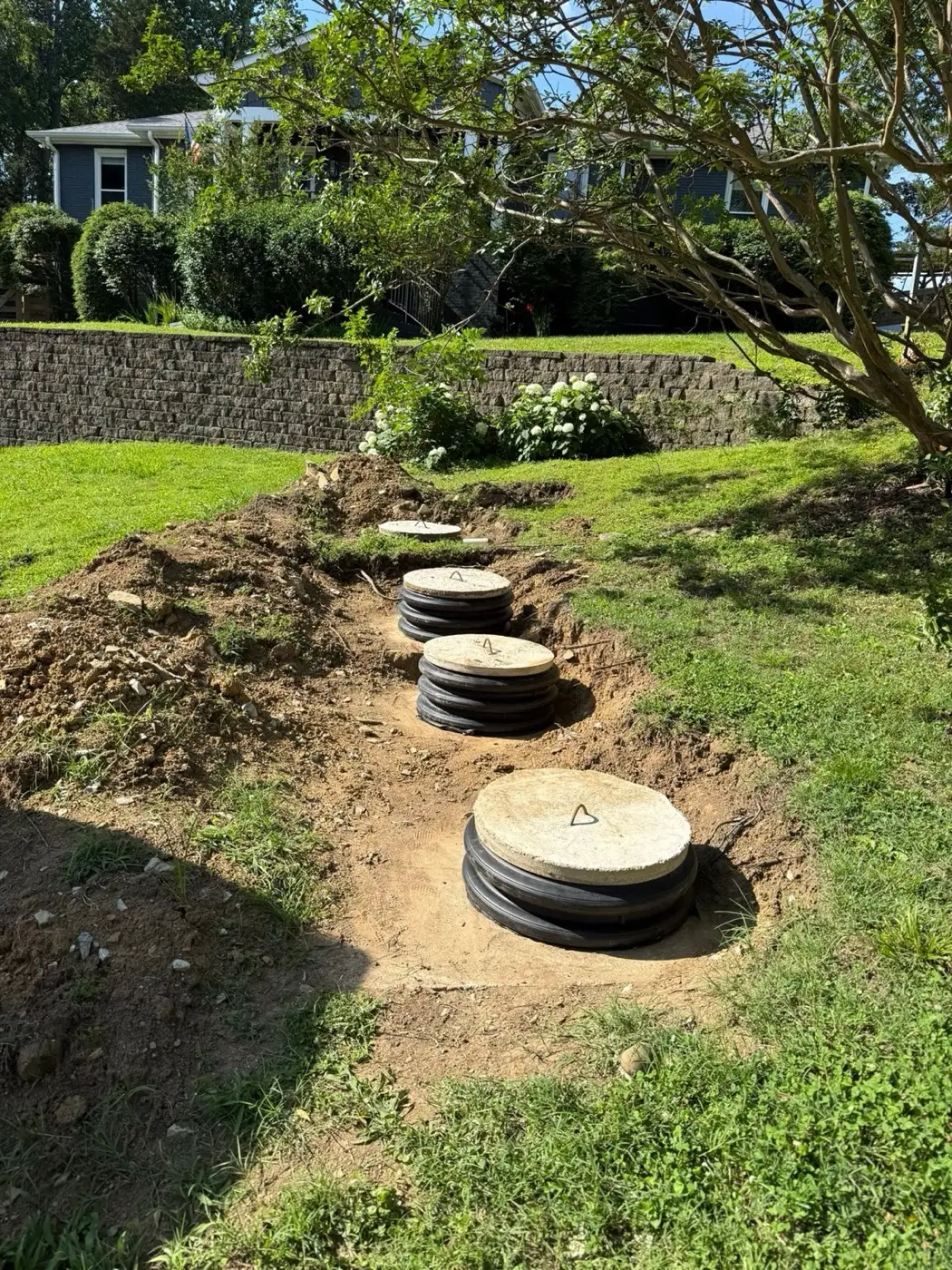Row of septic tank risers exposed on an installation