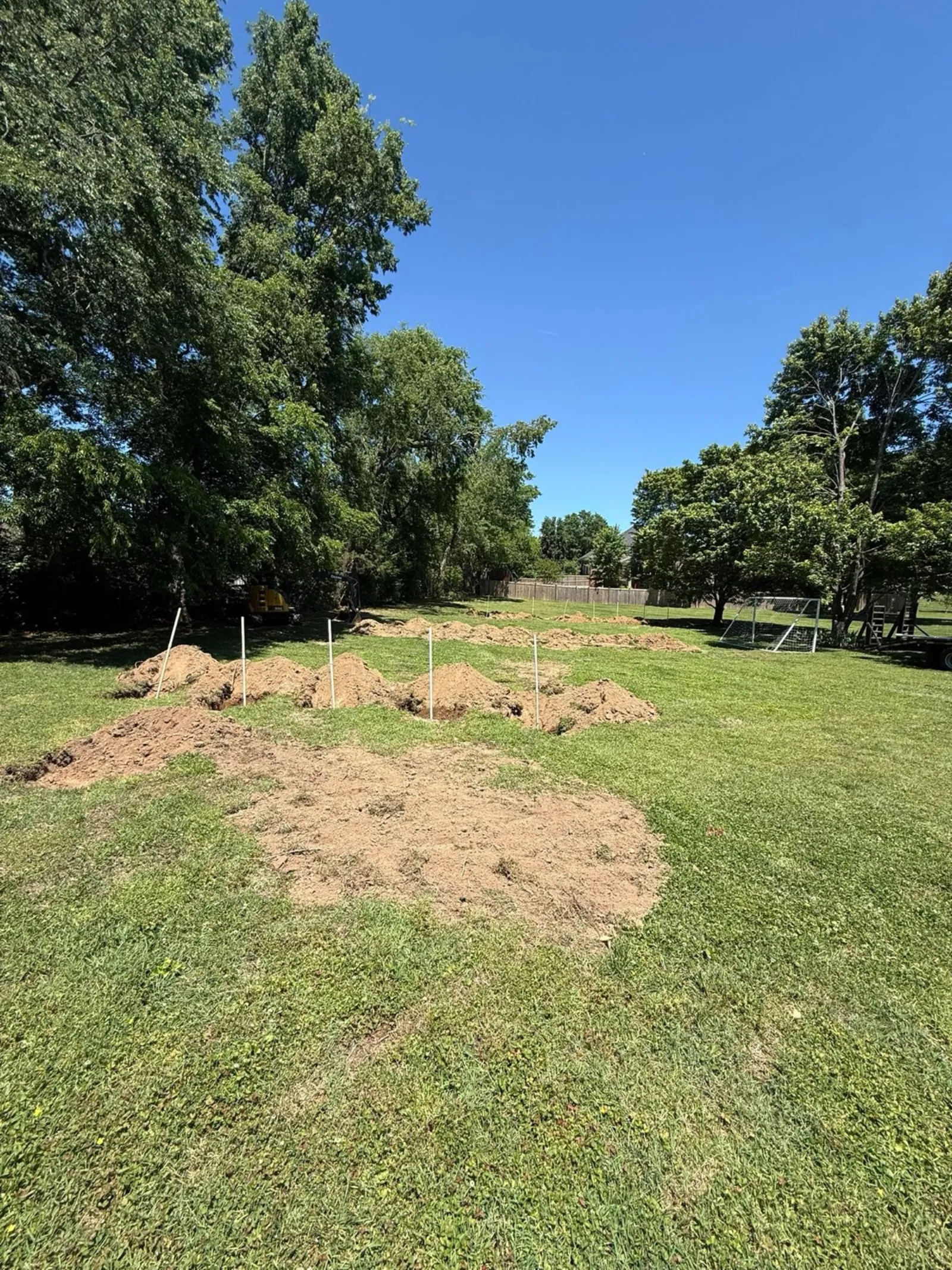 Fresh piles of dug soil spread across a grass lot in Middle Tennessee